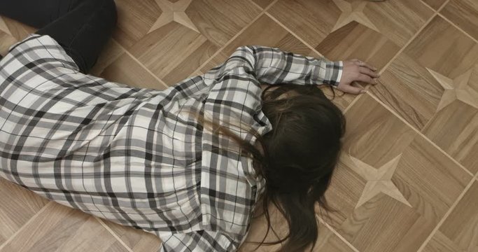 Unconscious or dead woman on floor.
