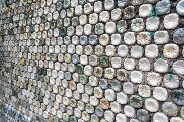 Bottle recycling: plastic bottles which have been set in concrete to form a bottle wall