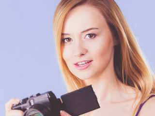 Blonde woman with camera on blue