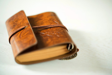 Old leather book on wood background