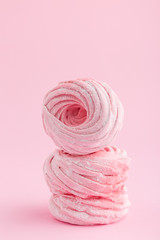 Homemade pink zephyr or marshmallow on pink background
