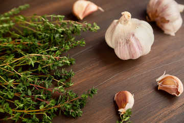 Composition of garlic and tyme. Fresh green thyme and garlic cloves.