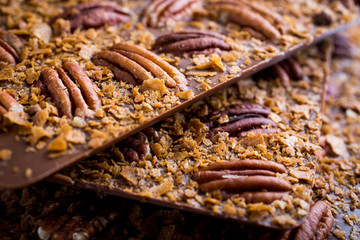 Milk Chocolate Bars with Pecan nuts stacked. Closeup shot.