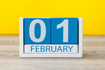 February 1st. Day 1 of february month, calendar on yellow workplace background. Winter time