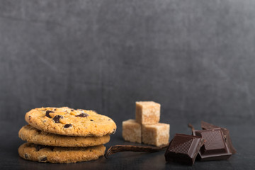 chocolate chip cookies with ingredients on a stone kitchen table