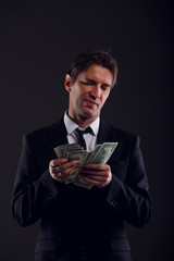 Picture of banker in suit counting dollars