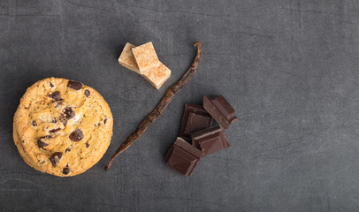 chocolate chip cookies with ingredients on a stone kitchen table