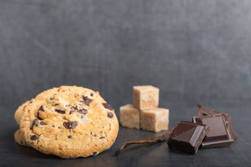 chocolate chip cookies with ingredients on a stone kitchen table