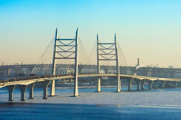 Cable-stayed bridge high-speed highway across the river in winter.