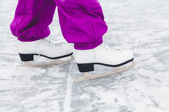 Legs in sports skates are rolled on ice