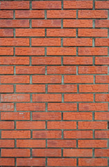 The vertical texture of the brick facade of the new red brick.