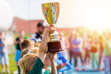 Young Athlete Holding Trophy. Youth Sport Soccer Team with Trophy. Boys Celebrating Sports...