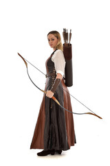 full length portrait of girl wearing brown  fantasy costume, holding a bow and arrow. standing pose...