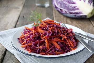 Salad with red cabbage and carrots in a plate