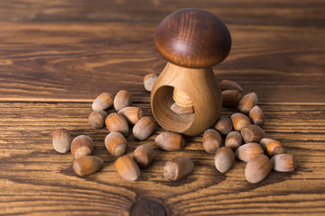 .hazelnuts and nutcracker on a wooden background