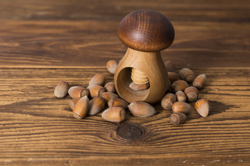 .hazelnuts and nutcracker on a wooden background