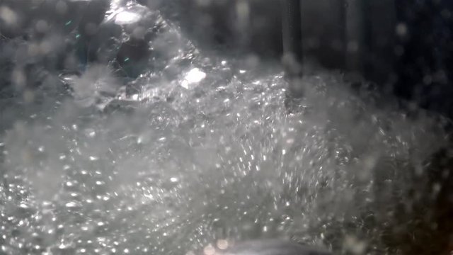 Brewing in large steel vats at the brewhouse. Foam on the surface of beer wort.