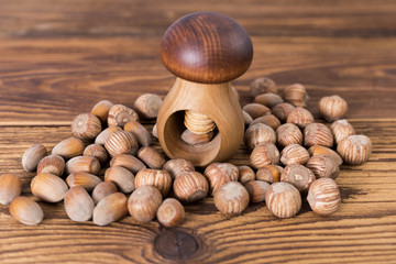.hazelnuts and nutcracker on a wooden background