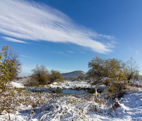 winter landscape old pond, the cloud and the hill