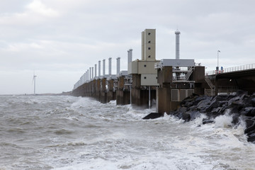 Dutch storm surge barrier closed with closing slides down to prevent flood