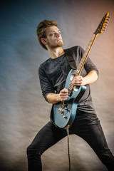 Fototapeta premium Young man playing electric guitar