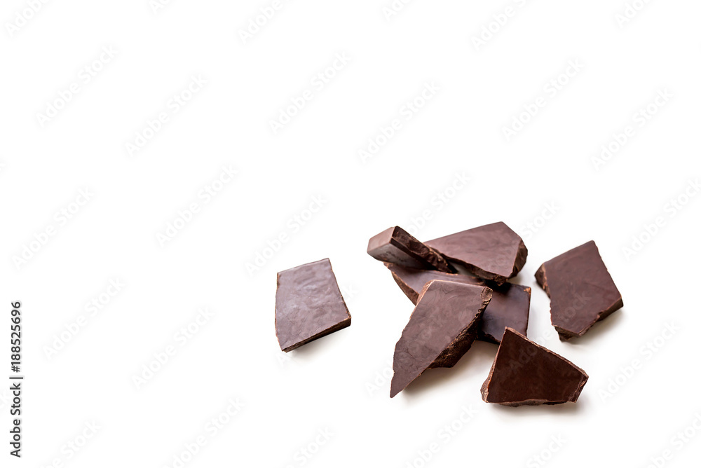 Wall mural broken dark chocolate bar isolated on white table. horizontal composition