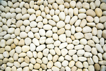 White pebbles background pile of white stones, close-up white rocks for background or texture.