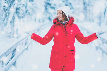 Fototapeta na wymiar Happy woman in a snow landscape