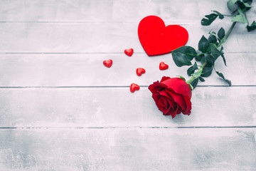 Red Rose and hearts on wooden background. Valentines day concept