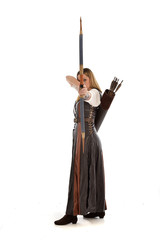 full length portrait of girl wearing brown  fantasy costume, holding a bow and arrow, on white studio background. 