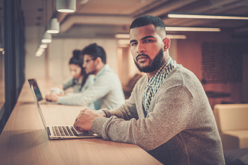 Young independent specialist in coworking office