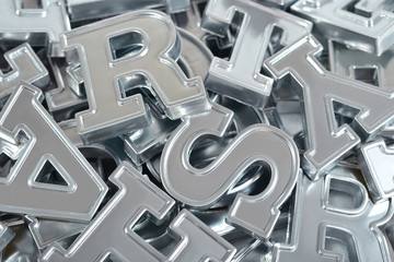 Silver alphabet letters close-up as background
