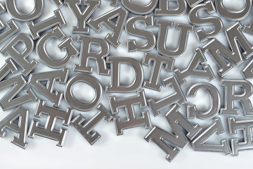 Silver alphabet letters on a white