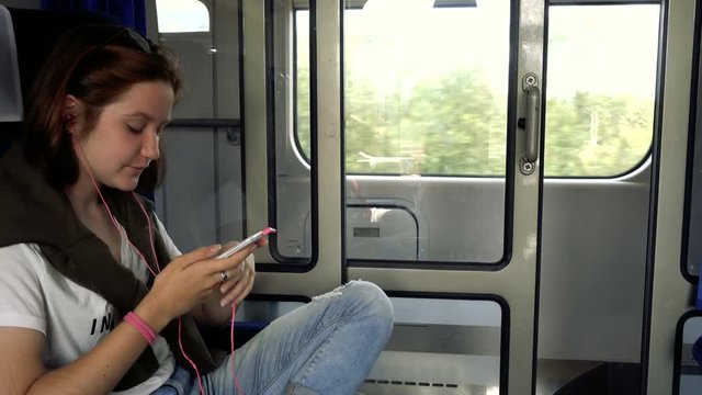 teen girl with the smartphone at the train
