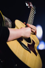 Acoustic guitarist performing on stage during concert