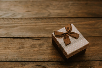 gift box with bow on wooden background