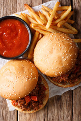 Hot American Delicious sandwiches Sloppy Joe and french fries, ketchup closeup on the table. Vertical top view