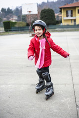little girl learns to skate with rollerblading