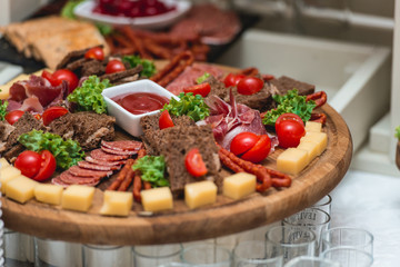 Mix cheese on wooden board with meat and bread