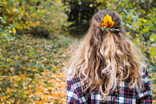autumn girl with yellow leafs in her hair