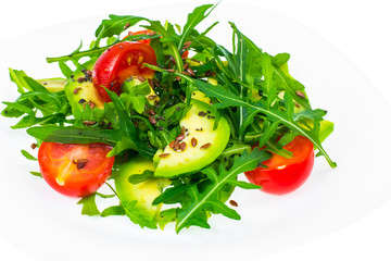 Light dietary salad from arugula, avocado, tomates and flax seed