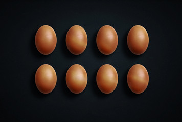 Brown eggs on a black background.