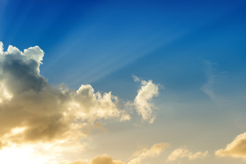 Rays of sun shining through dark clouds