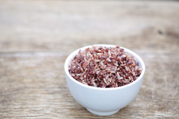 Organic brown rice on wooden table