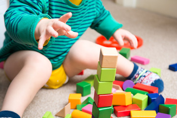 Child playing with building blocks learning new skills