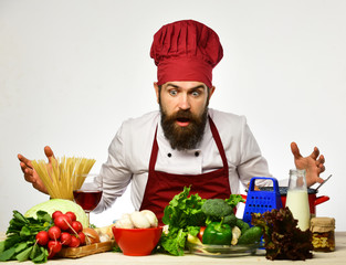 Cooking process concept. Man with beard looks at ingredients