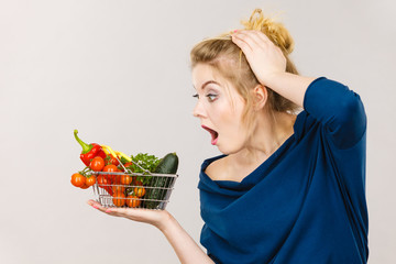 Woman with vegetables, shocked face expression