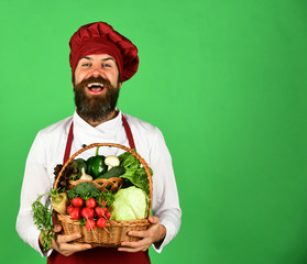 Chef holds cabbage, radish, broccoli with lettuce and garlic