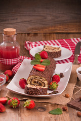 Chocolate roll with hazelnuts and strawberries. 
