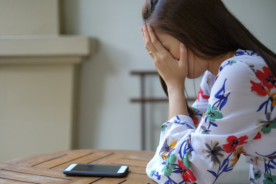 girl in emotional sad after get bad news in message from mobile phone